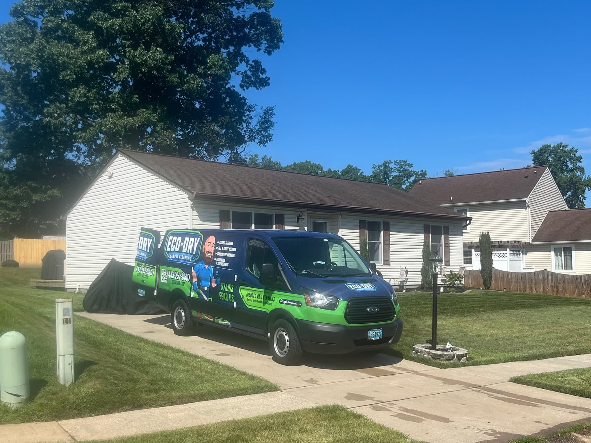 Eco-Dry van parked on a residential driveway with house and lawn visible