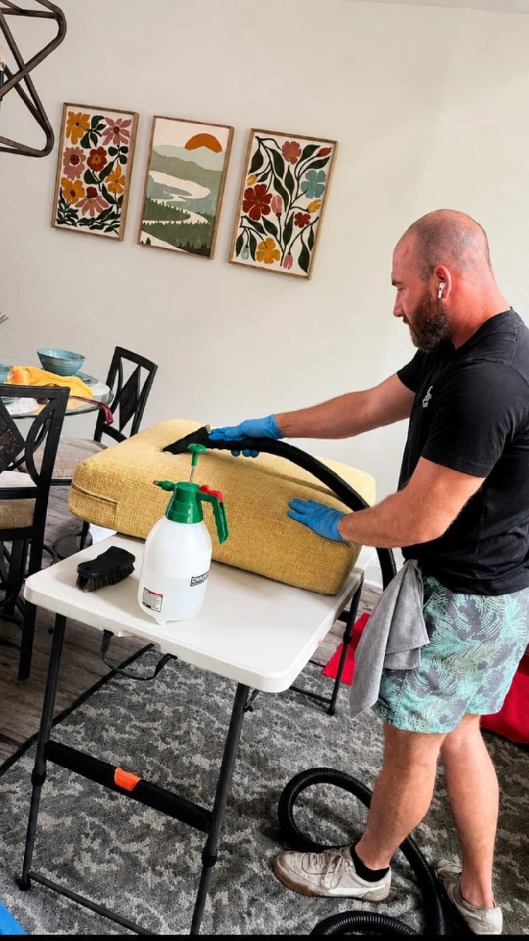 Technician cleaning a yellow seat cushion on a table