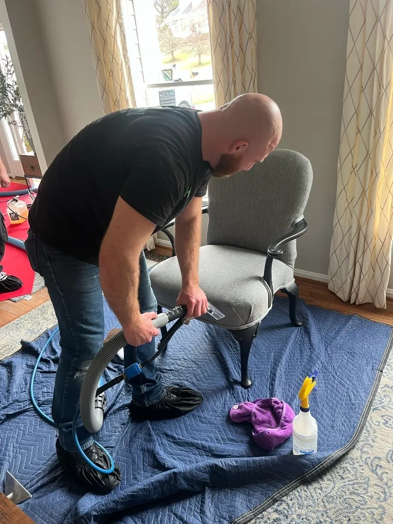 Eco-Dry technician cleaning upholstery with shoe covers and floor protection